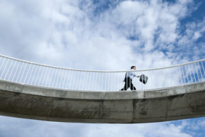 Caucasian businessman walking on elevated walkway